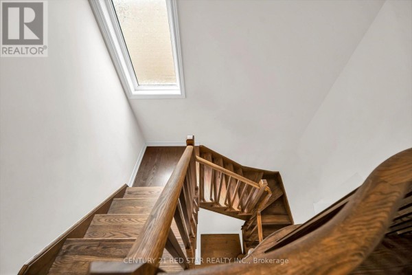 Wooden staircase with skylight and hardwood floors - 506 Brooks Street Shelburne