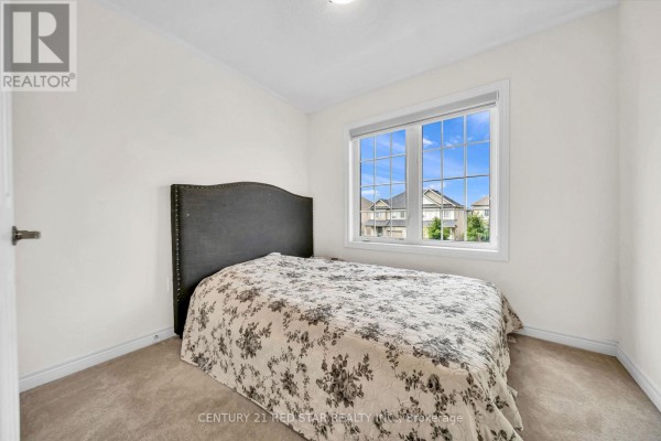 Bedroom with upholstered headboard and large window - 506 Brooks Street Shelburne