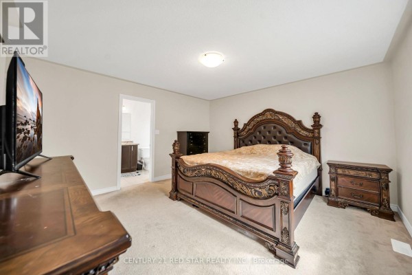 Ornate sleigh bed and TV in bedroom - 506 Brooks Street Shelburne