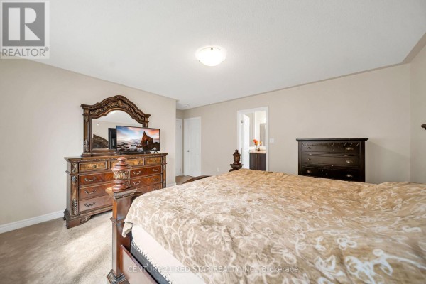Bedroom with bed, dresser, mirror, TV, and chest of drawers - 506 Brooks Street Shelburne