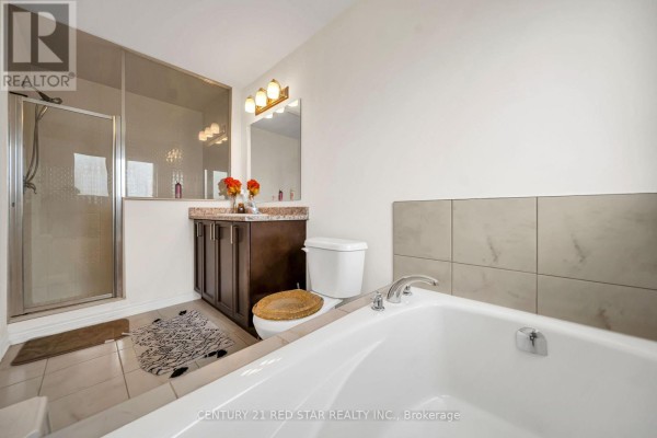 Bathroom with glass shower, dark wood vanity, soaking tub, and tile accent wall - 506 Brooks Street Shelburne
