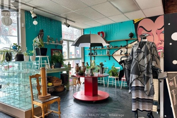 A black counter with glass displays and chalkboards advertising "South Side Thrift Gift". - 507 Victoria Ave E, Thunder Bay
