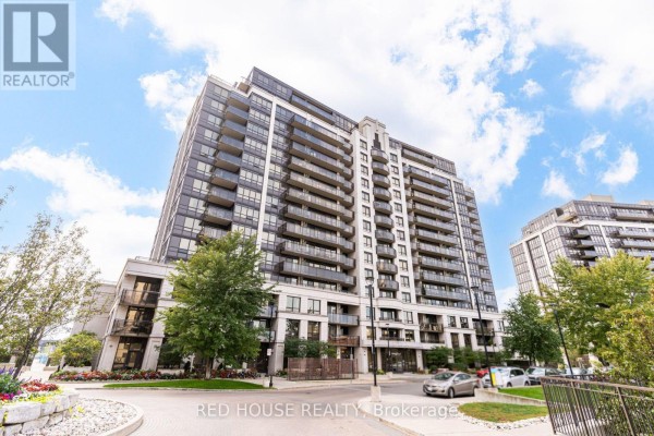 Exterior view of the condominium with trees, landscaping, and parked cars on a cloudy day. - 508 - 1070 Sheppard Avenue W, Toronto