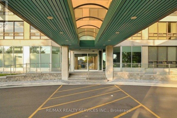 Close-up of the building entrance with glass doors and modern canopy. - 508 - 330 Mill Street S, Brampton