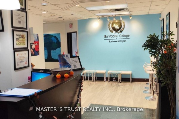Office room with large white table, chairs, bulletin board, and window overlooking city buildings. - 508 - 477 Richmond Street W, Toronto