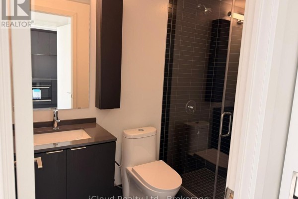 Bathroom with a vanity, toilet, and a glass-enclosed tiled shower. - 508 - 91 John Street North Street, Hamilton