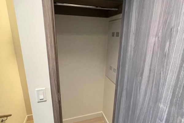 Empty closet with sliding wood doors and a shelf. - 508 - 95 Mcmahon Drive, Toronto