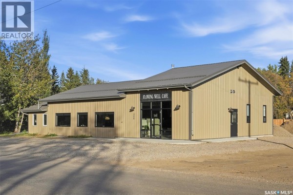 Front view of a tan metal-clad commercial building with a grey metal roof and a glass entrance. - 508 Railway Street E, Hepburn
