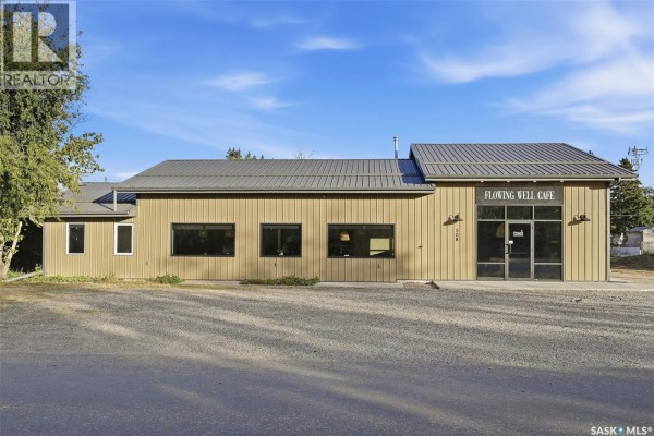 Exterior of a commercial building with tan metal siding, grey metal roof, and dark-framed windows. - 508 Railway Street E, Hepburn