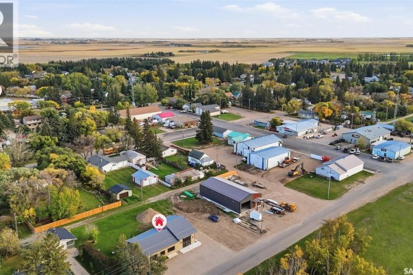 Aerial view of a rural town showing the commercial building surrounded by other structures and landscape. - 508 Railway Street E, Hepburn