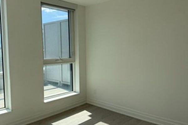 Interior room with light grey walls, a large window, and hardwood floors. - 508b - 8 Rouge Valley Drive, Markham