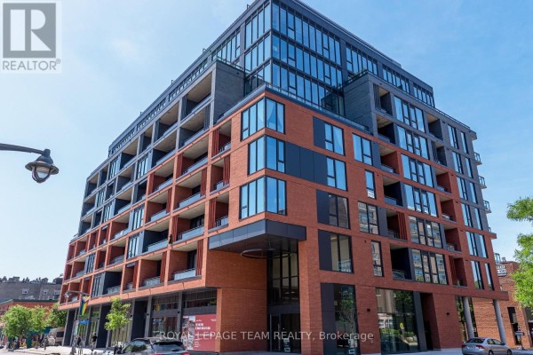 Exterior of a contemporary multi-story apartment building with brick and glass facade. - 509 - 10 James Street, Ottawa