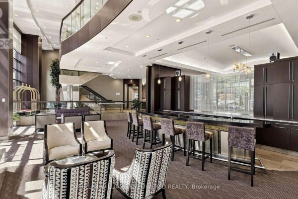 Lobby lounge area with upholstered seating, a wet bar, and dark wood cabinets. - 509 - 33 Sheppard Avenue E, Toronto