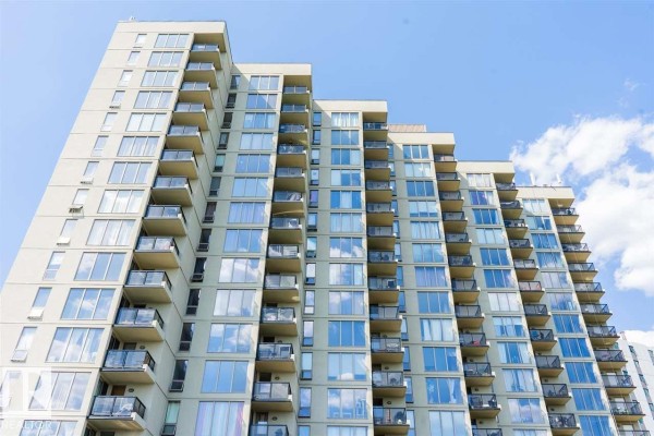 Exterior view of a tall, beige apartment building with many windows and balconies. - #509 10149 Saskatchewan Dr Nw, Edmonton