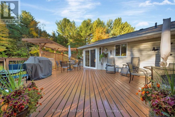 Spacious wooden deck with outdoor furniture and a pergola at the back of the house. - 509 Concession 2 Road E, Trent Hills