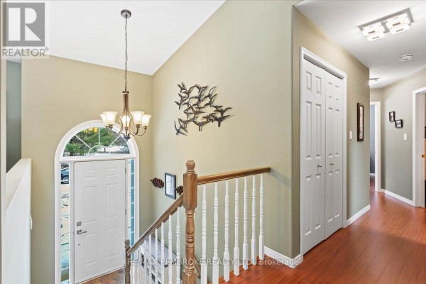 Interior foyer with a staircase, arched window above the front door, and double doors. - 509 Concession 2 Road E, Trent Hills