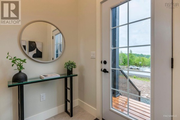View from the front door looking up a staircase with light wood treads and neutral walls. - 5093 26 Woodlark Lane, Middle Sackville