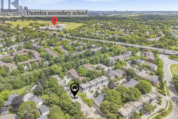 Aerial view highlighting the townhouse complex, proximity to the Ladies Golf Club of Toronto, and surrounding greenery. - 51 - 210 Royal Orchard Boulevard, Markham