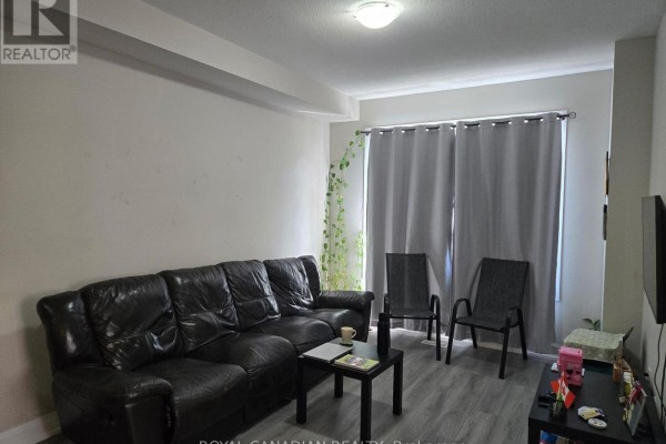 Living room with a black leather sofa, two chairs, coffee table, and grey curtains. - 51 - 40 Zinfandel Drive, Hamilton