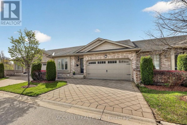Front exterior of townhouse complex showing the facade, entrance, and garages. - 51 - 765 Killarney Road, London North