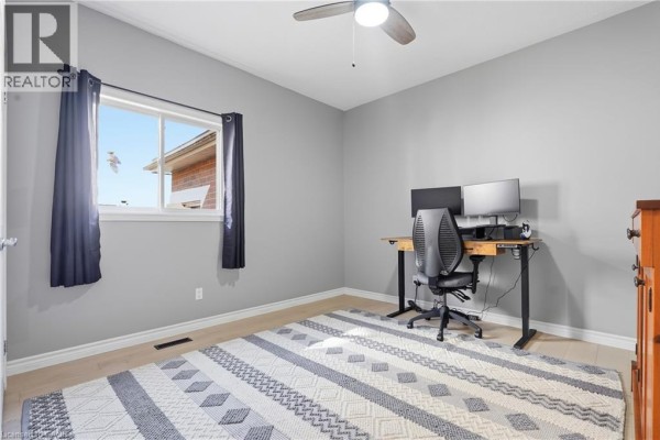 Office with desk, dual monitors, ergonomic chair, ceiling fan, and rug - 51 Autumn Ridge Trail Kitchener