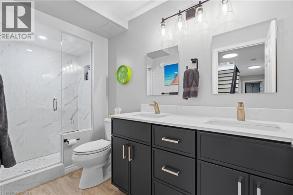 Modern bathroom with double vanity, marble shower, and gold fixtures - 51 Autumn Ridge Trail Kitchener