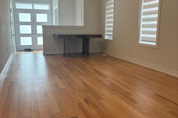 Living room with hardwood floors, large windows, and entryway with double doors. - 51 Danielle Moore Circle, Toronto