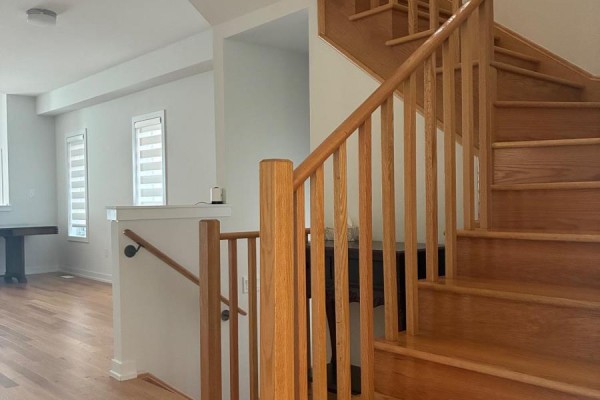 Wooden staircase with railings and banister in a bright, airy home interior. - 51 Danielle Moore Circle, Toronto