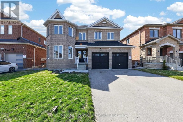 Front view of a large brick house with a double garage and green lawn under a cloudy sky. - 51 Furniss Street, Brock