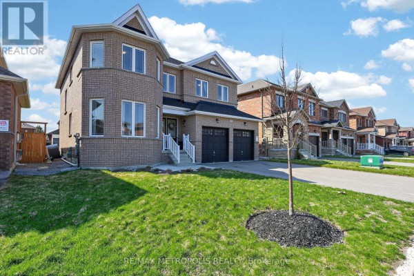 Side exterior view of a two-story brick house with a lawn and young tree on a bright day. - 51 Furniss Street, Brock
