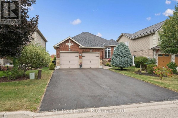 Wide view of a brick house with a stone base, two garage doors, and a paved driveway. - 51 Mcgowan Street, Centre Wellington