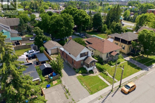 Aerial view of a residential street with mature trees and various houses. - 51 Melbourne Street W, Kawartha Lakes