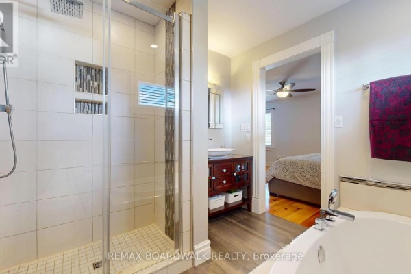 Modern bathroom with glass shower and soaking tub, open to bedroom - 51 Ormond Street Brockville