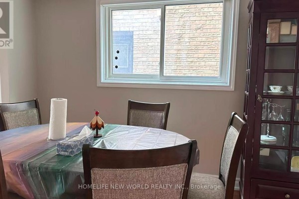 Dining room with a round table, upholstered chairs, and a dark wood display cabinet. - 51 Park Lane Circle, Richmond Hill