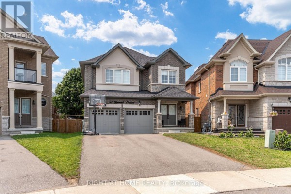 Exterior of a two-story house with a double garage, viewed from the driveway. - 51 Rosewell Crescent, Halton Hills