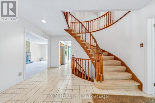 Curved wooden staircase with carpeted steps & tiled hall - 51 Sanderson Crescent Richmond Hill