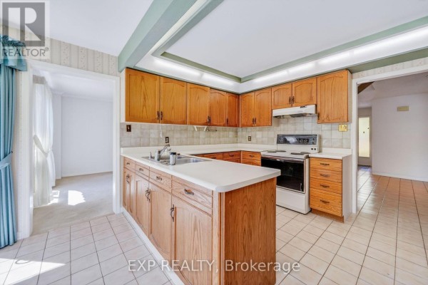 Wood cabinets, white counters & stove in kitchen - 51 Sanderson Crescent Richmond Hill