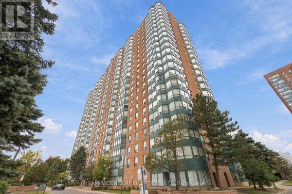 Low angle view of a tall, beige apartment building with many windows and green trim. - 510 - 135 Hillcrest Avenue, Mississauga