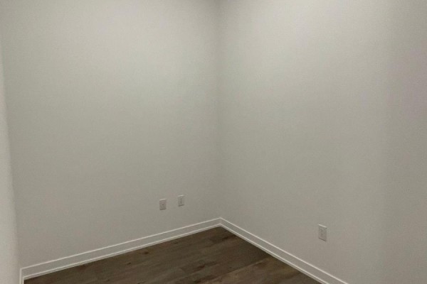 Empty room with light wood floors and white walls, suitable for an office or bedroom. - 510 - 60 Honeycrisp Crescent, Vaughan