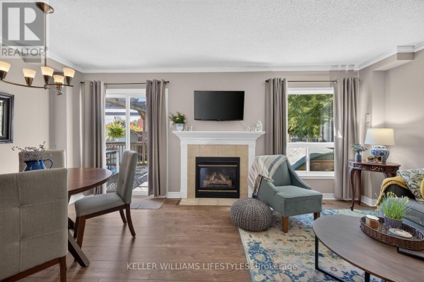 Welcoming foyer with beige walls, round mirror, and decorative table with flowers. - 510 Blackwater Place, London North