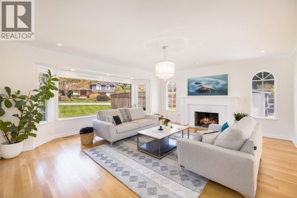 Bright white kitchen with a large island, dining table, and stainless steel appliances. - 510 Newdale Place, West Vancouver