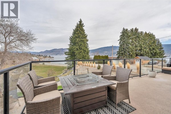 Front view of the property showcasing modern design and carport. - 5100 Wilson Road, Summerland