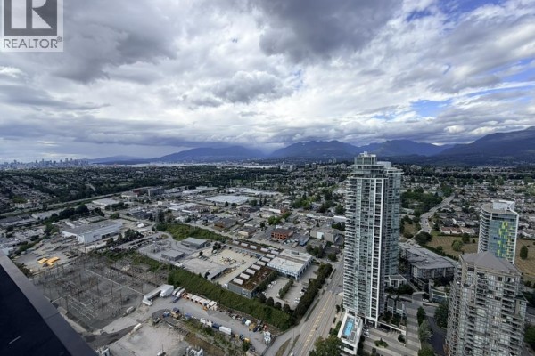 Expansive view of Vancouver and surrounding mountains from apartment balcony. - 5101 2108 Gilmore Avenue, Burnaby