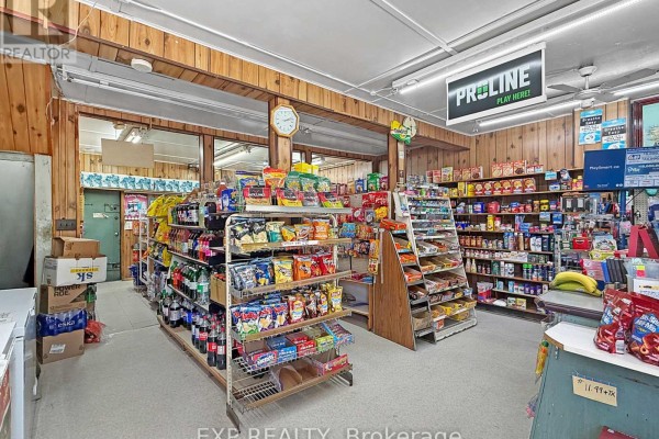 Interior view of a convenience store with shelves stocked with snacks, drinks, and other goods. - 511 Quebec Street, London East