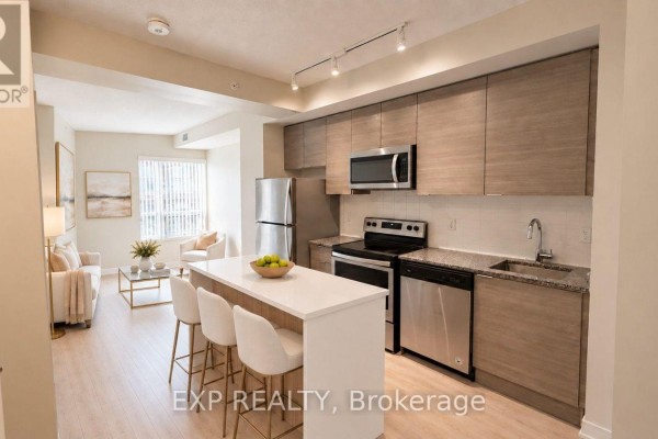 Open concept kitchen with light wood cabinets, stainless steel appliances, and a breakfast bar. - 512 - 621 Sheppard Avenue E, Toronto