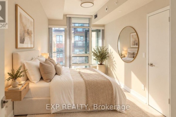 Bedroom with a queen-sized bed, floor-to-ceiling windows, and a round mirror. - 512 - 621 Sheppard Avenue E, Toronto