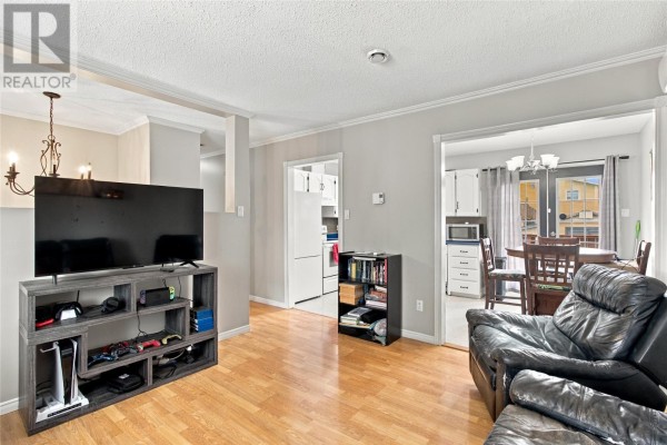 View from the living room showing an entertainment unit, a doorway to the kitchen and dining area. - 512 Main Road, St John S