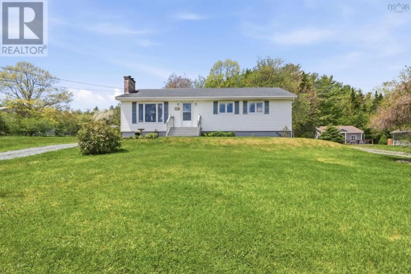 Exterior front view of a single-story white home with white siding and a chimney. - 512 Windsor Junction Road, Windsor Junction