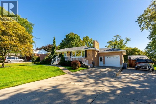 Side view of the bungalow, showing the attached garage, driveway, and shed. - 512 Zone Street, Plympton Wyoming