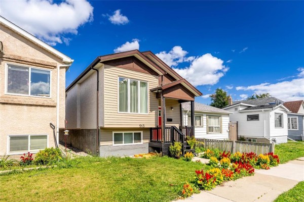 Modern kitchen with black countertops, white cabinets, and stainless steel appliances - 513 Jamison Avenue, Winnipeg